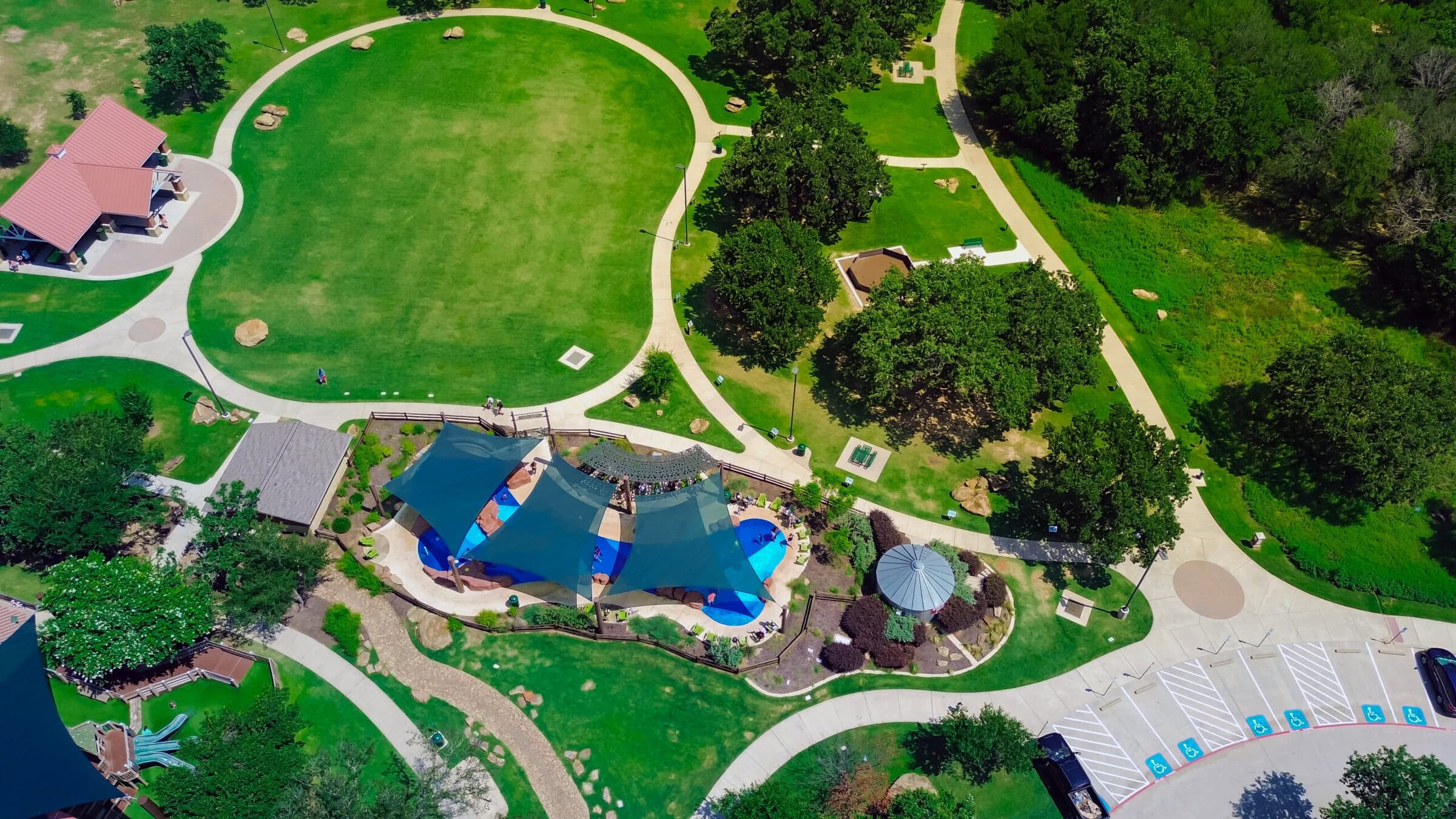 Suburban park in Flower Mound, Texas with pavilion shelter, splash pad sail shades