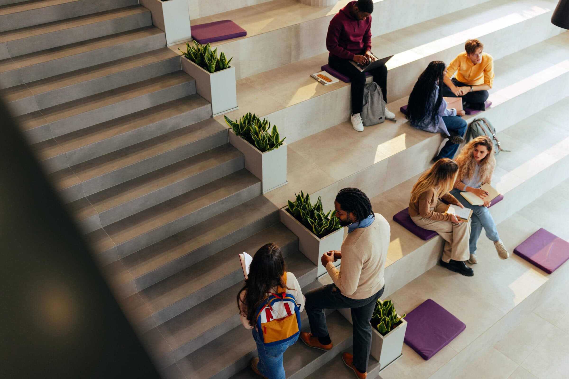University students collaborating and studying in a modern campus area