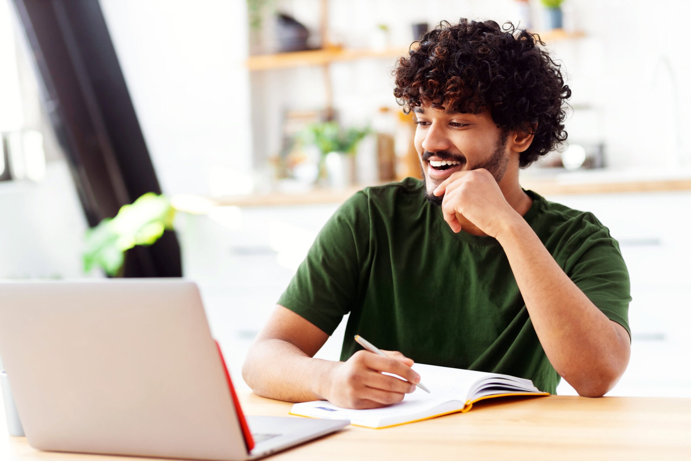 Young man using laptop for watching webinar