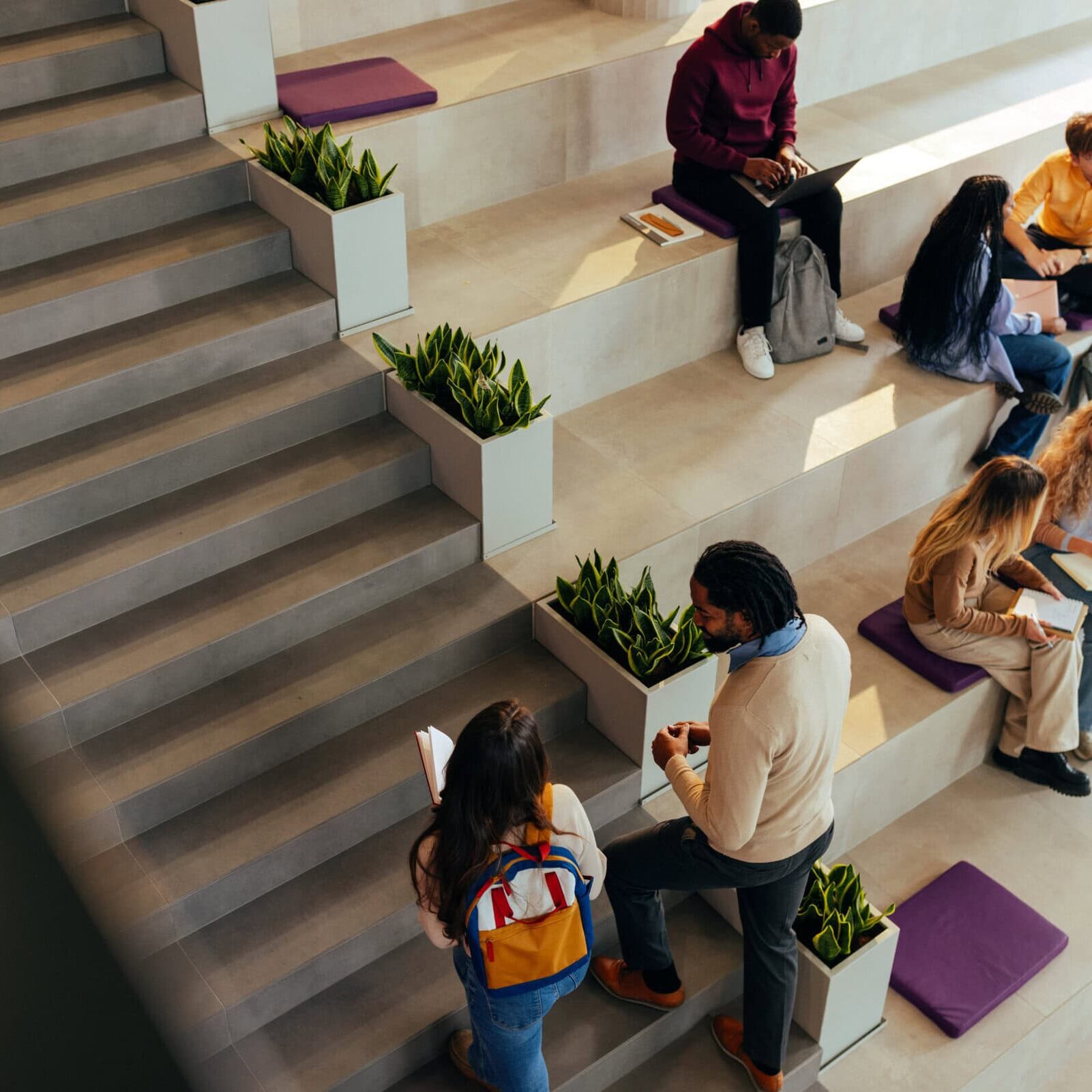 University students collaborating and studying in a modern campus area