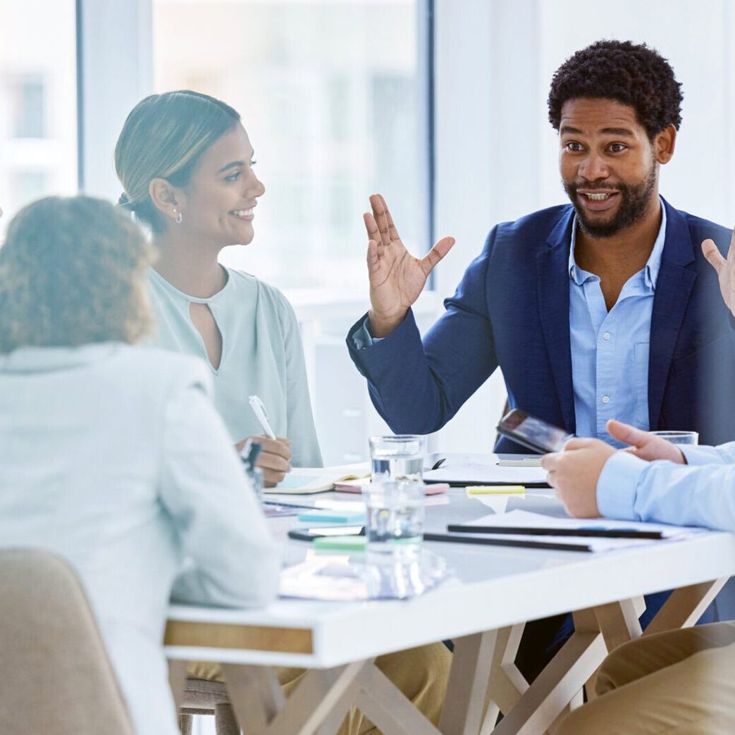 Happy, explaining and black man in a meeting for a presentation, planning and workshop. Business, communication and employees talking about a corporate project, idea or plan in a team seminar.